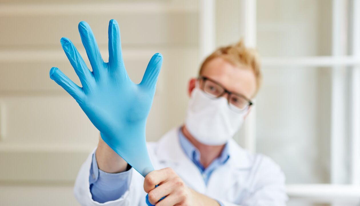 Doctor puts on gloves to perform massage to prevent prostatitis