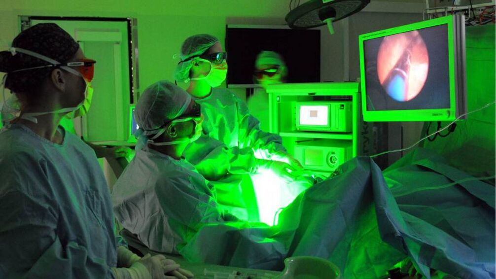 Doctor performs laser treatment for prostate inflammation